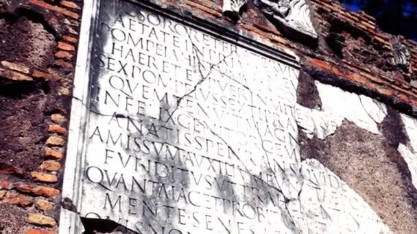 Marmeren plaat met Latijnse inscriptie op oude grafmonument op de oude Via Appia — Stockvideo