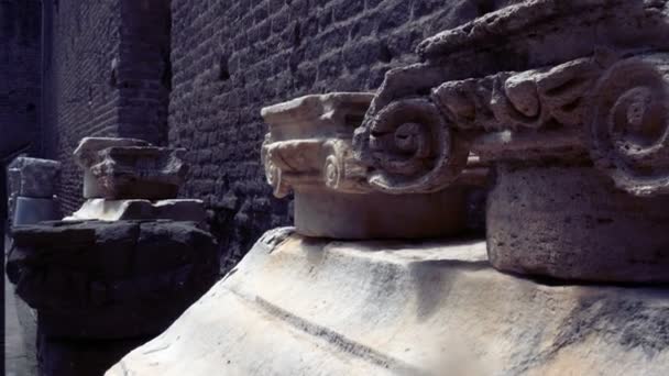 Tracking shot on the remains of capitals of ionic column capitals — Stock Video