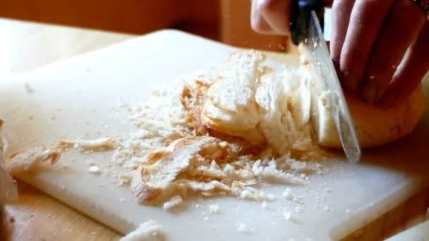 Um cozinheiro, cortar um pouco de pão seco em pequenos cubos para a massa dos bolinhos tiroleses — Vídeo de Stock