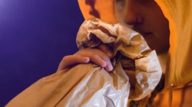 Turuncu kapüşonlu sweatshirt genç kız bir torbaya sarılmış süper alkollü içki içer