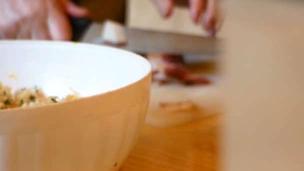 Lady cuts the speck into small cubes for the preparation of Tyrolean dumplings — Stock Video