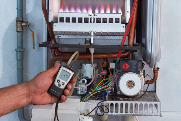 Repair of a gas boiler, setting up and servicing by a service department. Adjustment of gas pressure by manometer