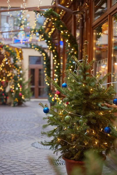 Christmas decoration of streets and exteriors of shops, sparkling garlands