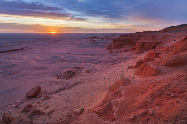 Photo of the Flaming cliffs in Mongolia, found in the Gobi Desert region taken during dawn  