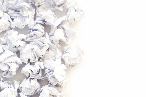 Pile of crumpled paper on a white background.
