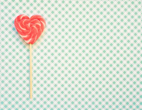 Red and pink lollipop. Candy in the form of heart.