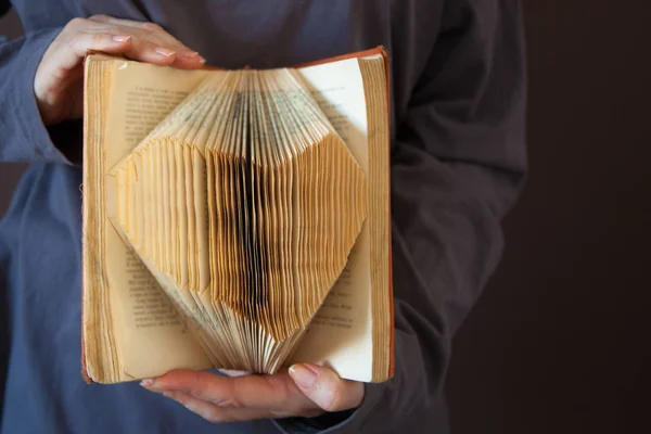 pages of a book curved into a heart shape