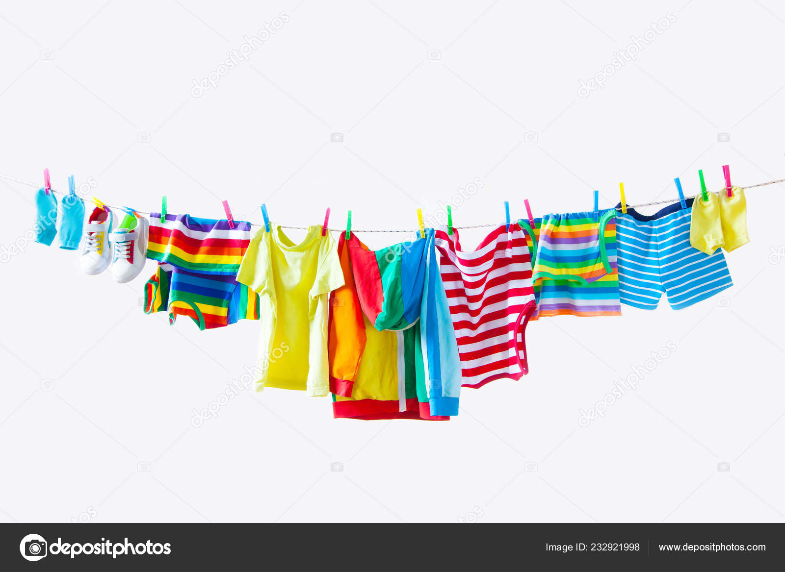 Clothesline Hanging Baby Clothes Yellow Background Stock Photo by