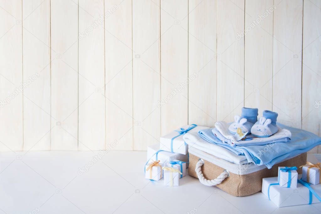 Wish list or shopping overview for pregnancy and baby shower. View from above. White wooden older board