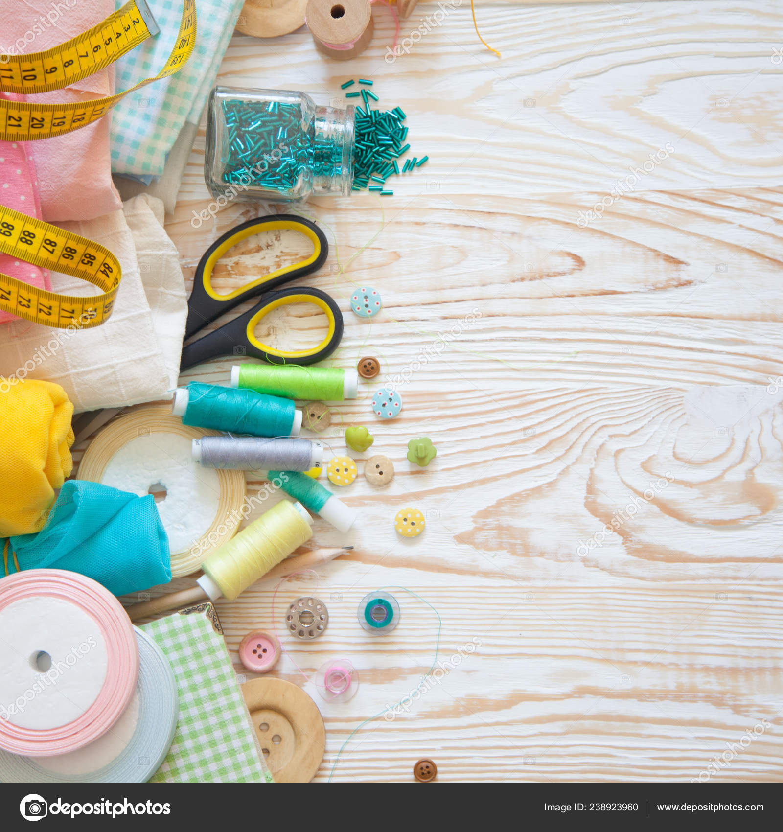 Creative sewing supplies and accessories on a table Stock Photo by