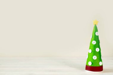 Alternatif Noel ağacı külah. Noel ağacı, iplik ve iplik yapılmış. Noel ağacı düğmeleri ile dekore edilmiştir. El yapımı ağaç.