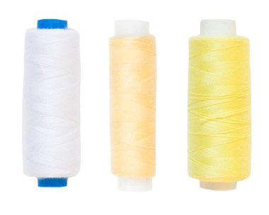 Coils with yellow and white thread. Isolated. White background.