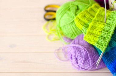 Closeup of basket with colorful yarn clews. Knitted Socks. clipart