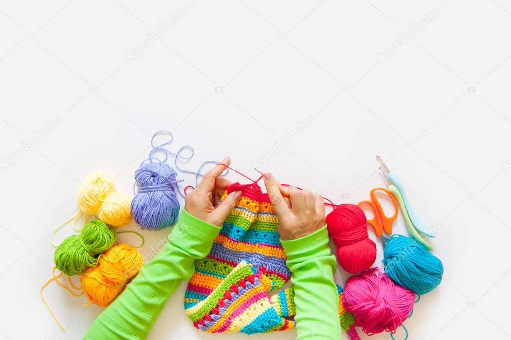 Women's hobby. Needlework and crocheting and knitting. Bright yarn. Concept of women's leisure.