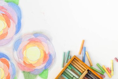 Çiçekler pastel ile çizilmiş sanat. Kalem, işaretleri ve beyaz bir arka plan üzerinde sanatçının eller.