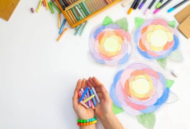 Çiçekler pastel ile çizilmiş sanat. Kalem, işaretleri ve beyaz bir arka plan üzerinde sanatçının eller.