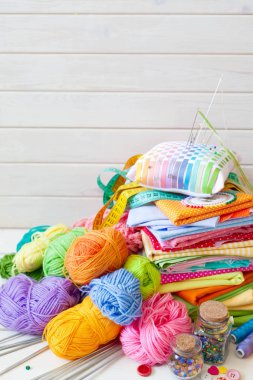 Renkli kumaş, iplik, iplik, boya kalemi ve boyalar. Renkli materyaller masanın üzerinde yaratıcı çalışma için. İğne işi yap. Her şey için el yapımı.