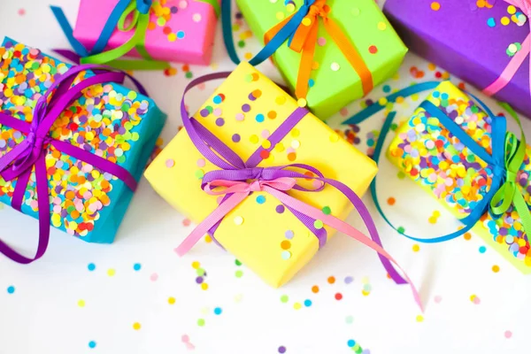 Colored gift boxes with colorful ribbons. White background. Gifts for Christmas or a birthday.