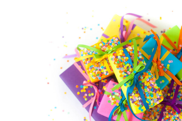 Colored gift boxes with colorful ribbons. White background. Gifts for Christmas or a birthday.