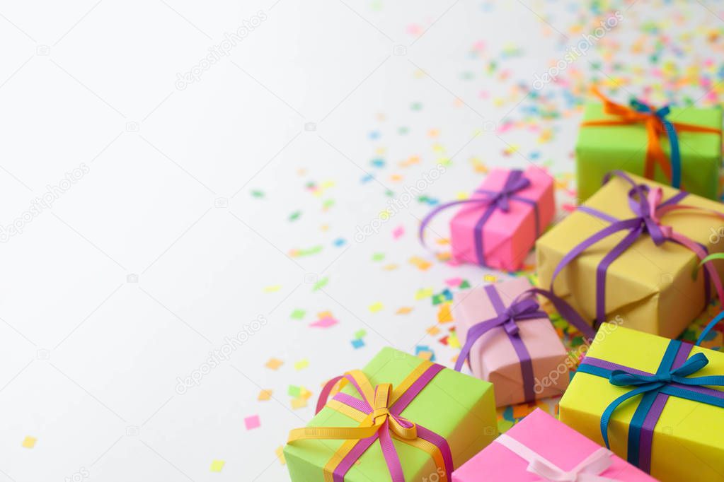 Colored gift boxes with colorful ribbons. White background. Gifts for Christmas or a birthday.