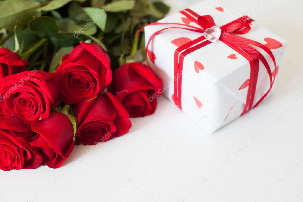 Gift box with hearts. Red roses. White background.