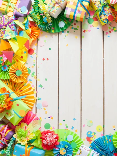 Colored flags garlands and gifts on wooden background