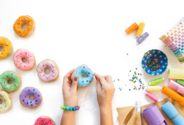 Food is sewed from fabric for a children's game in a shop or cafe. Donuts, hamburger, pizza, sausages, French fries, Japanese rolls.