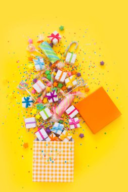 Yellow background. A box with accessories for a birthday, a party or a new year.