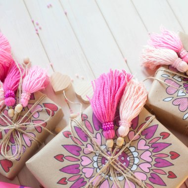 Pembe püsküllü. Beyaz ahşap arka plan. Kadın el sanatları. Yaratıcılık kavramı.