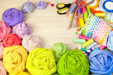 Dikiş aksesuarları beyaz bir arka plan üzerinde yalan. Ölçüm bandı, iplik, kumaş, İğne mili ve iğneler dikiş için.