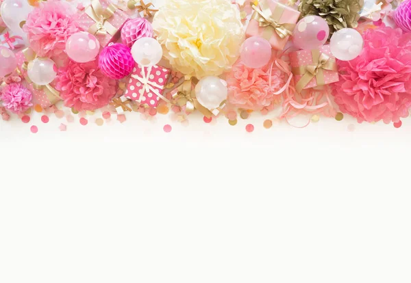 Pink and gold confetti, tinsel, serpentine and gifts. White background.