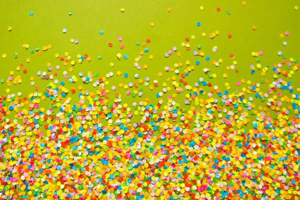 Confetti scattered in different colors on a white background. Festive confetti. The decor for the party.