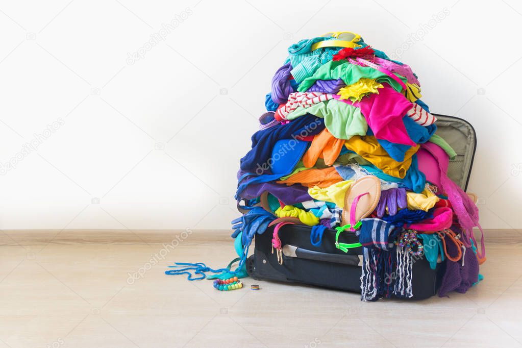 Fees for travel and holidays. Clothes stacked in a bunch of flowers. Women's wardrobe. Many things.