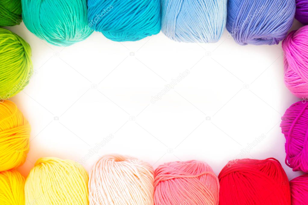 Colorful rainbow yarn for knitting. Hooks, scissors and knitting needles.
