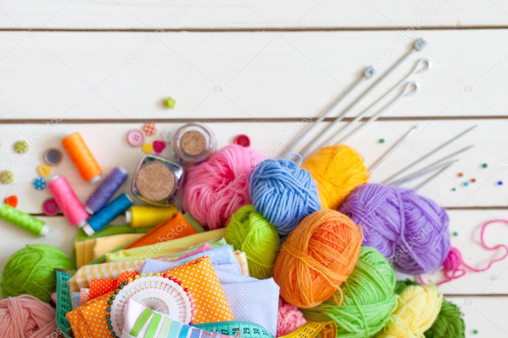 Colored fabric, yarn, thread, crayons and paints. Colored materials for creative work on the table. Do needlework. Everything for handmade.