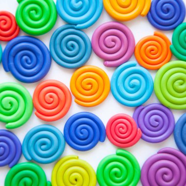 Hamuru arka plan. Plastik farklı renk renkli spiraller bükülmüş.