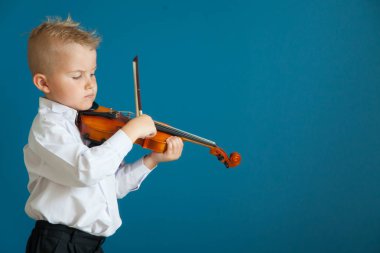 Çocuk keman çalıyor. Çocuk müzik eğitimi.
