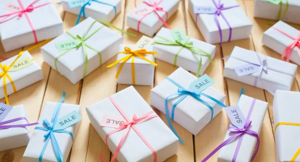 White boxes with bright satin and rep-ribbons.