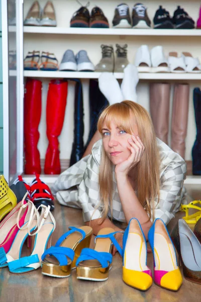 Woman choosing shoes on your closet for shoes.