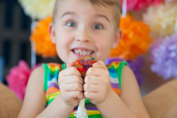 kid holding stress relief grape balls, squeezing balls, mesh squishy balls hand wrist toy