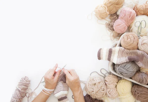 Women crochet and knitting from beige yarn. View from above. Woo — Stock Photo, Image