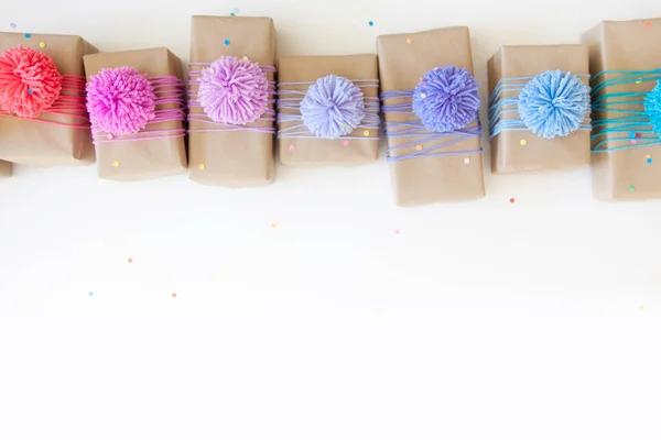 Colored gift boxes with colorful ribbons and pompon. White backg — Stock Photo, Image