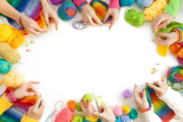 Women crochet and knitting from colored yarn. View from above. — Stock Photo, Image