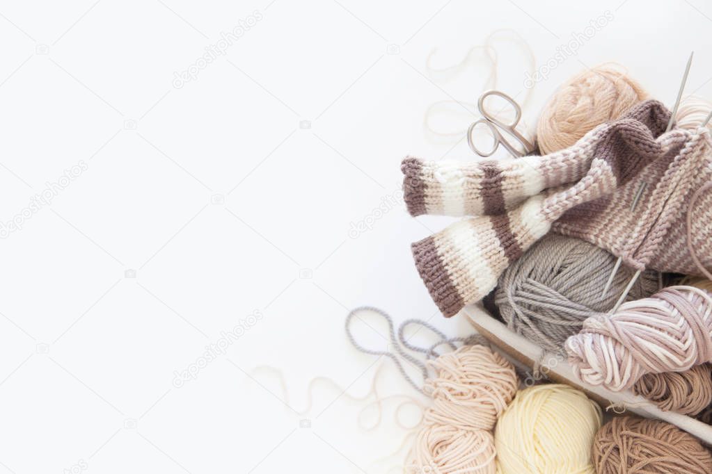 Neutral beige yarn for knitting is in the basket. Woolen warm so
