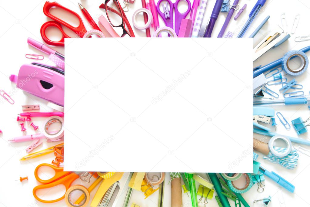 School supplies on checked paper notepad background