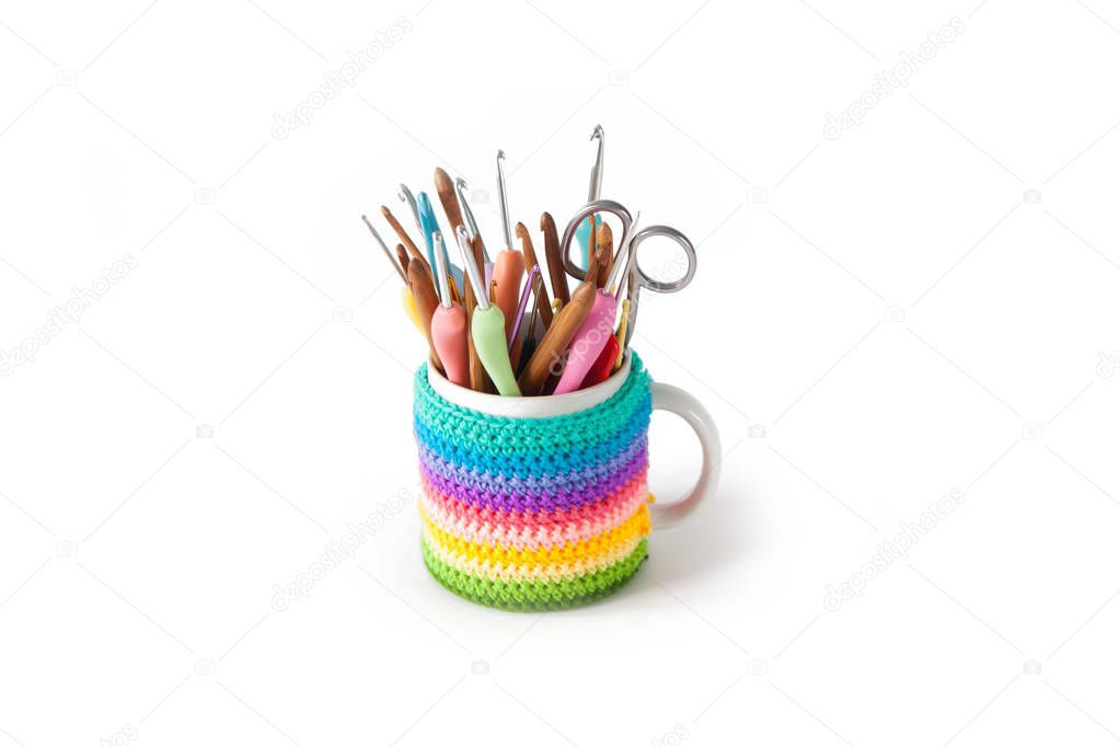 Hooks and knitting needles stand in a colored circle. White back