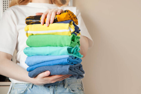 Женщина складывает одежду вертикально на полке шкафа. Японский язык
