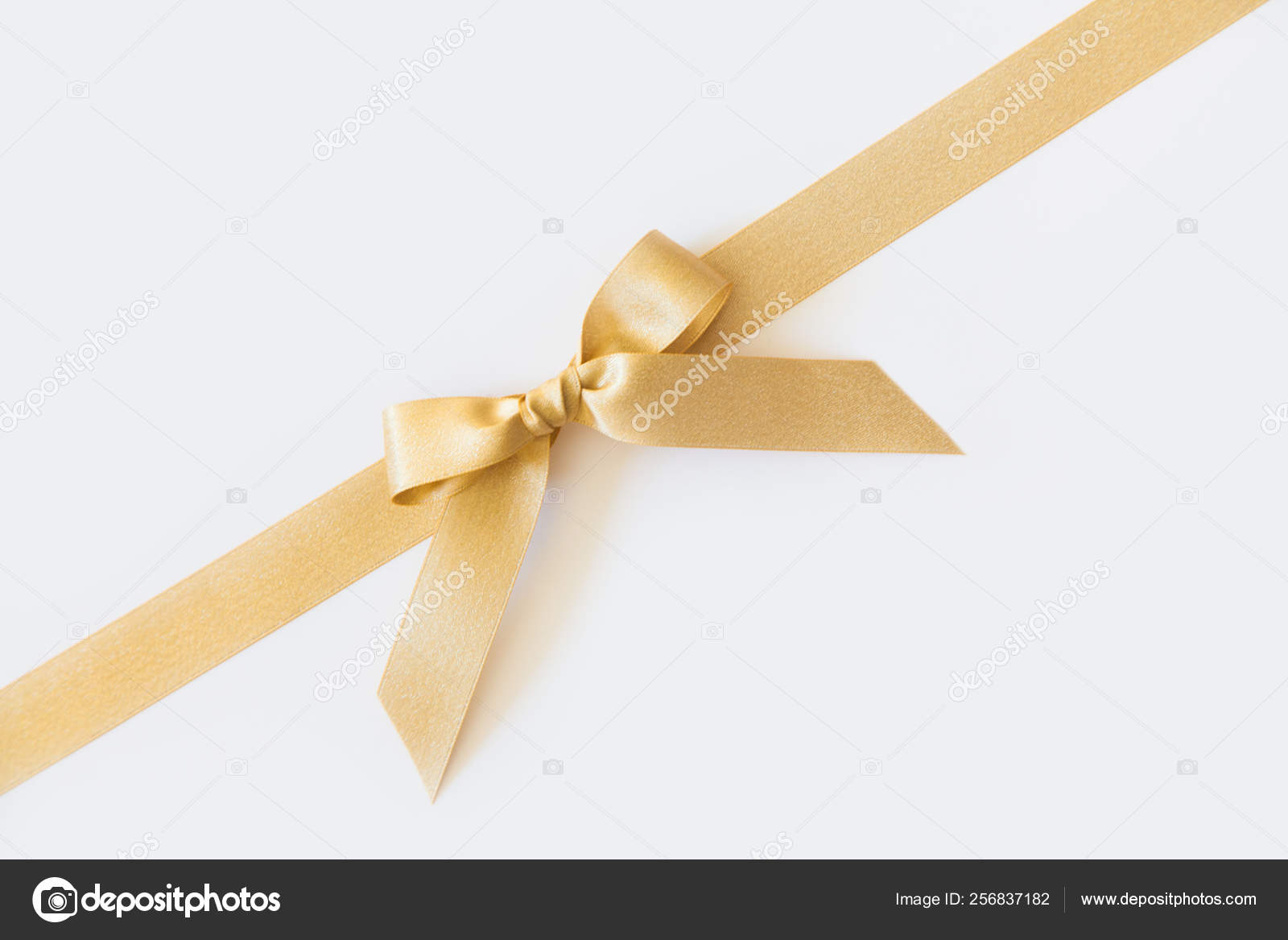 Gold ribbon with a bow as a gift on a white background Stock Photo by  ©dalivl@yandex.ru 256837182