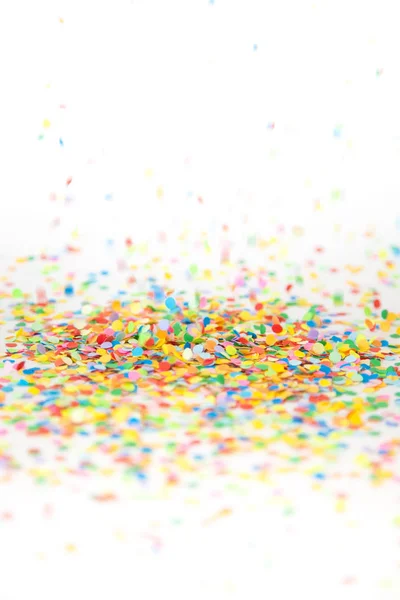 Colored confetti flying on white background — Stock Photo, Image