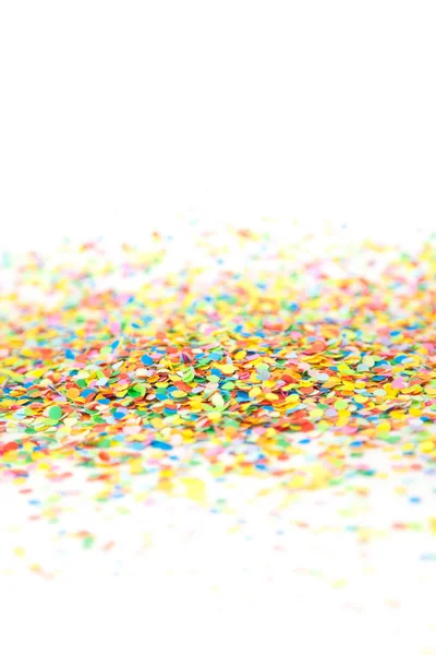 Färgade konfetti flyger på vit bakgrund — Stockfoto